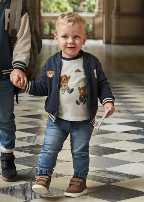 Toddler wearing Mayoral baby denim jogger pants, tapered legs for easy movement