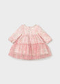 Back of the pink floral tulle dress showing the long sleeves, tiered skirt and zip closure