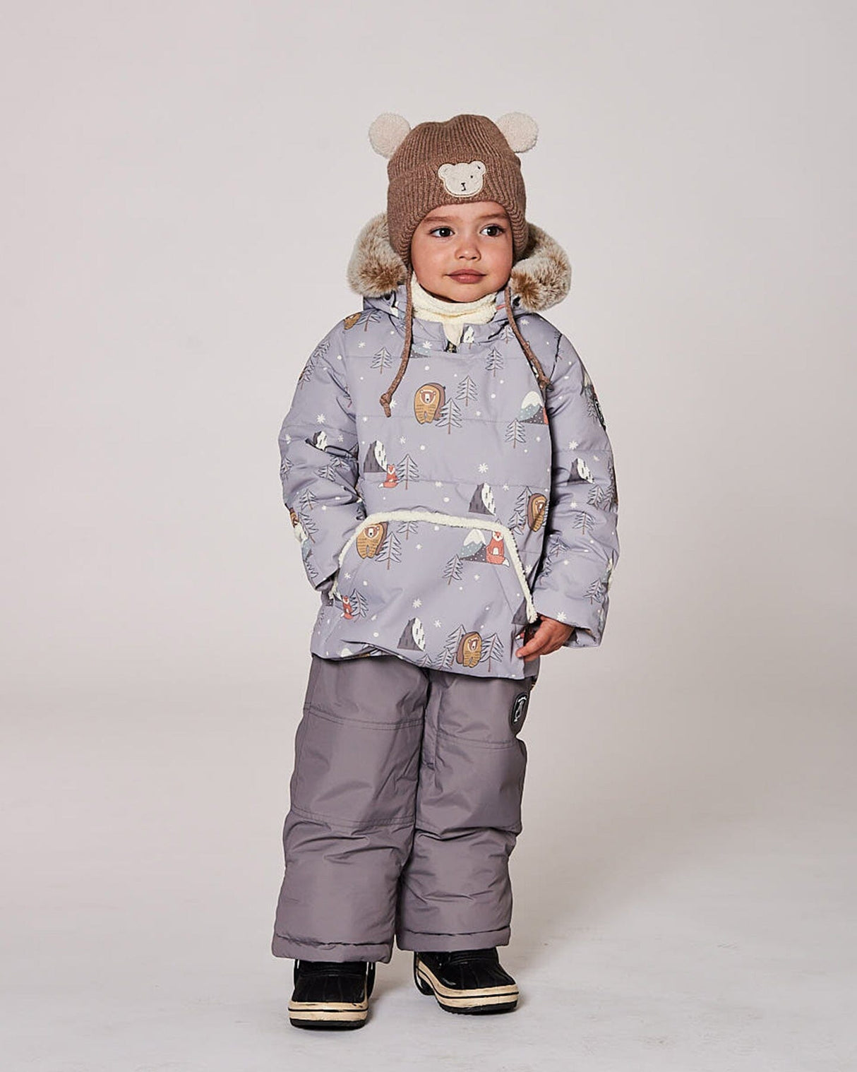 Lifestyle photo of toddler wearing the gray Baby Snug two-piece snowsuit outdoors
